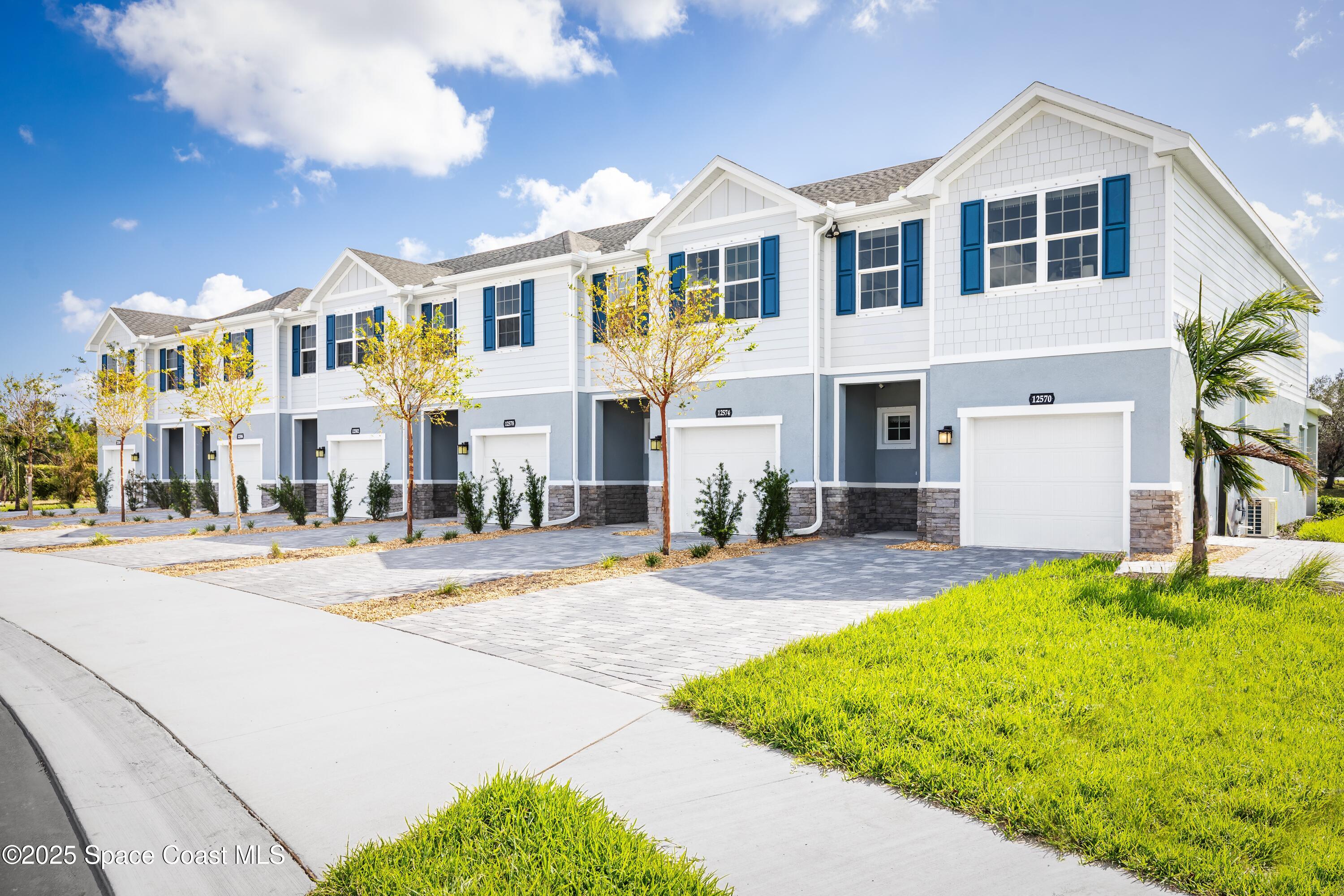 1808 Kendall Pointe Place Melbourne, FL 32935 - Photo 1 of 11 a front view of a house with a yard and garage