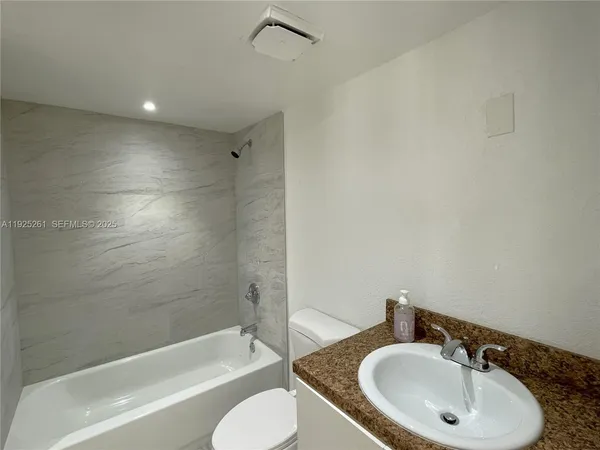 a bathroom with a sink toilet and bathtub