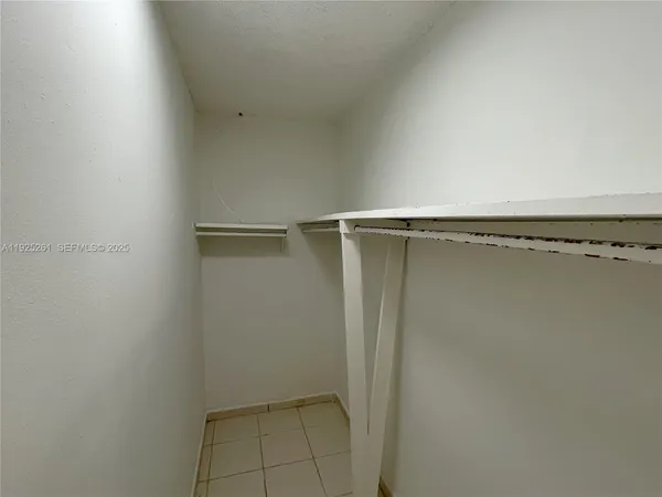 an empty room with sliding door and windows