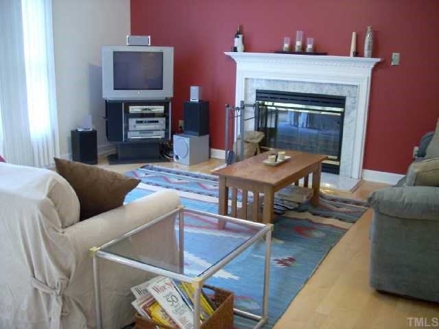 5321 Bakers Mill Road Durham, NC 27707 - Photo 6 of 12 a living room with furniture a fireplace and a flat screen tv