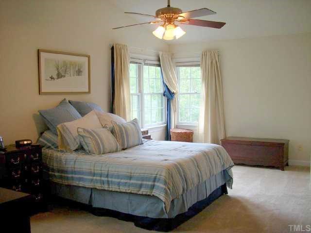 5321 Bakers Mill Road Durham, NC 27707 - Photo 8 of 12 a bedroom with a bed and window