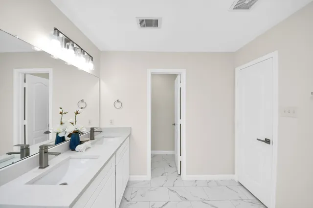 a bathroom with a double vanity sink and a mirror
