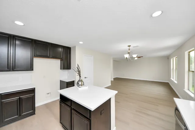 a kitchen with cabinets and stainless steel appliances