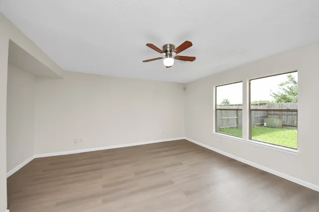 wooden floor in an empty room with a window