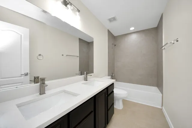 a bathroom with a bathtub a sink and a large mirror