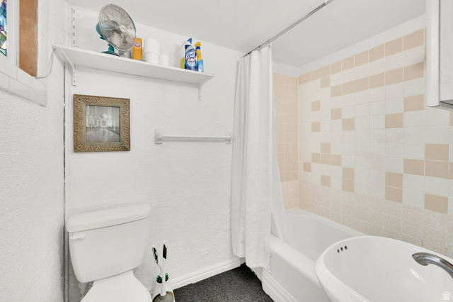 4635 Box Elder Street Murray, UT 84107 - Photo 14 of 21 Full bathroom featuring toilet and shower / bathtub combination with curtain