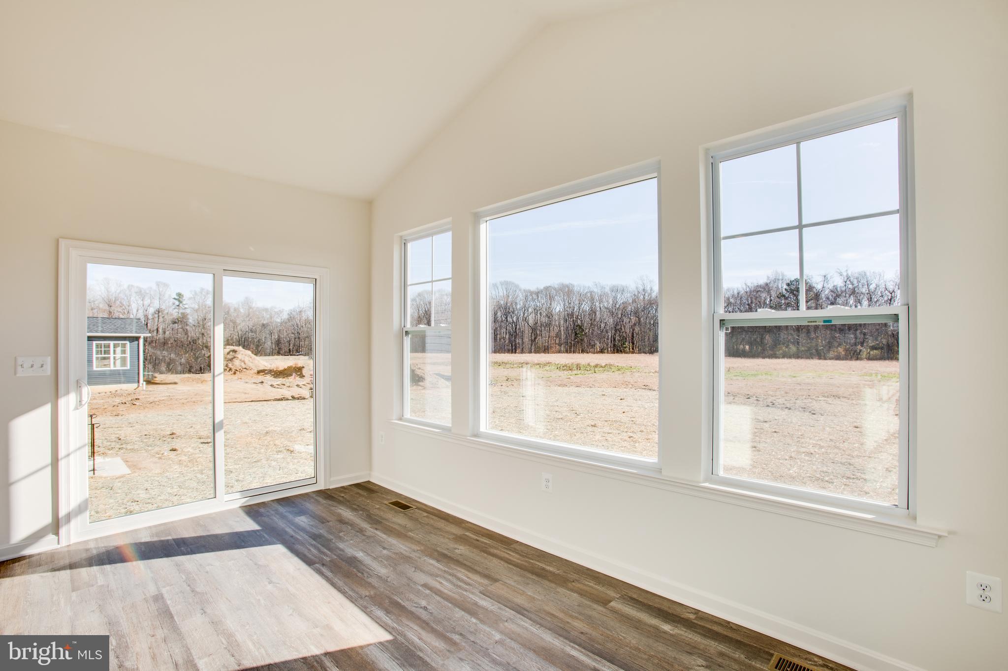 2107 Warrenton Road Fredericksburg, VA 22406 - Photo 12 of 58 a view of an empty room with wooden floor and a window
