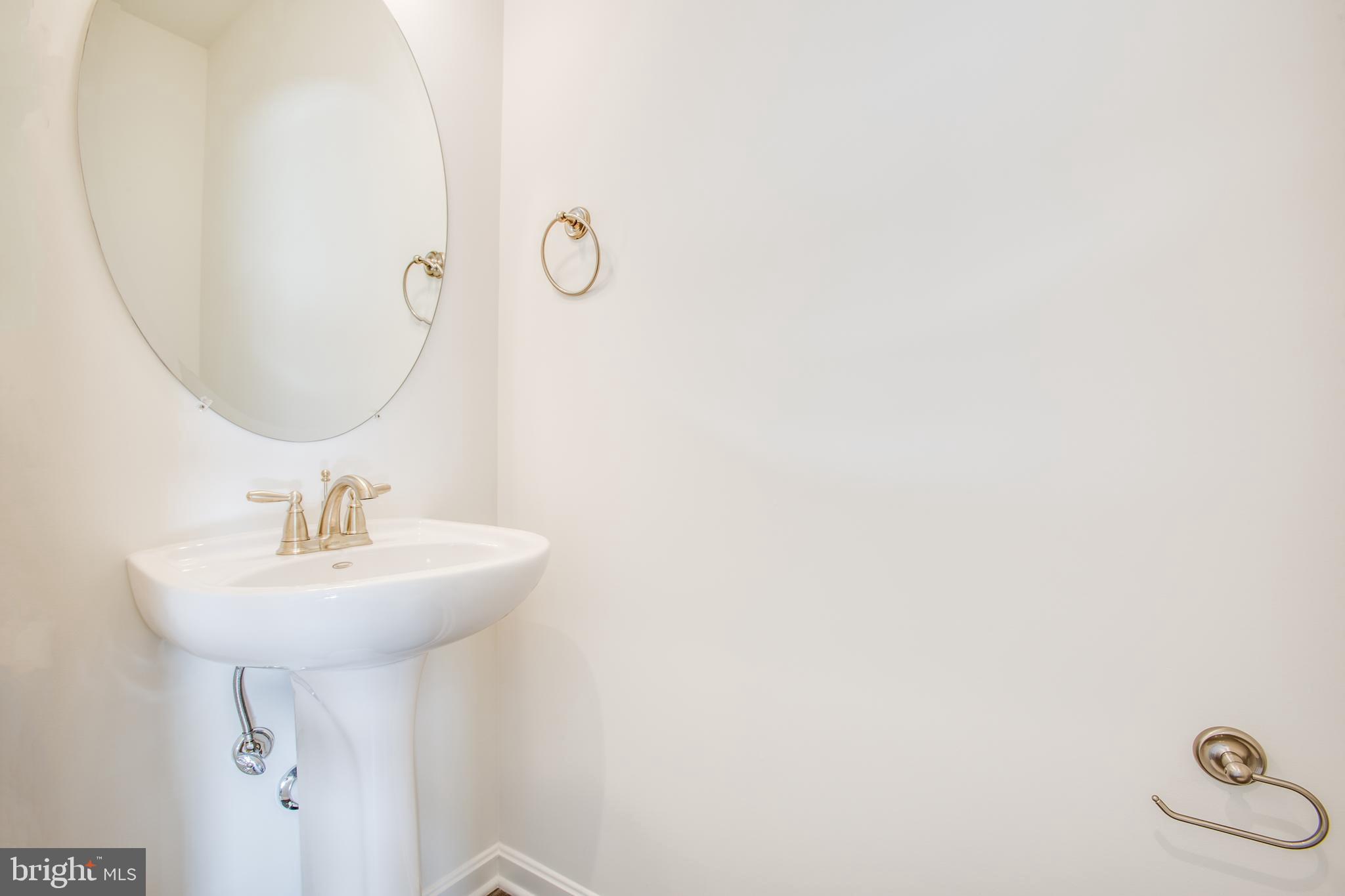 2107 Warrenton Road Fredericksburg, VA 22406 - Photo 20 of 58 a bathroom with a sink a mirror and a shower