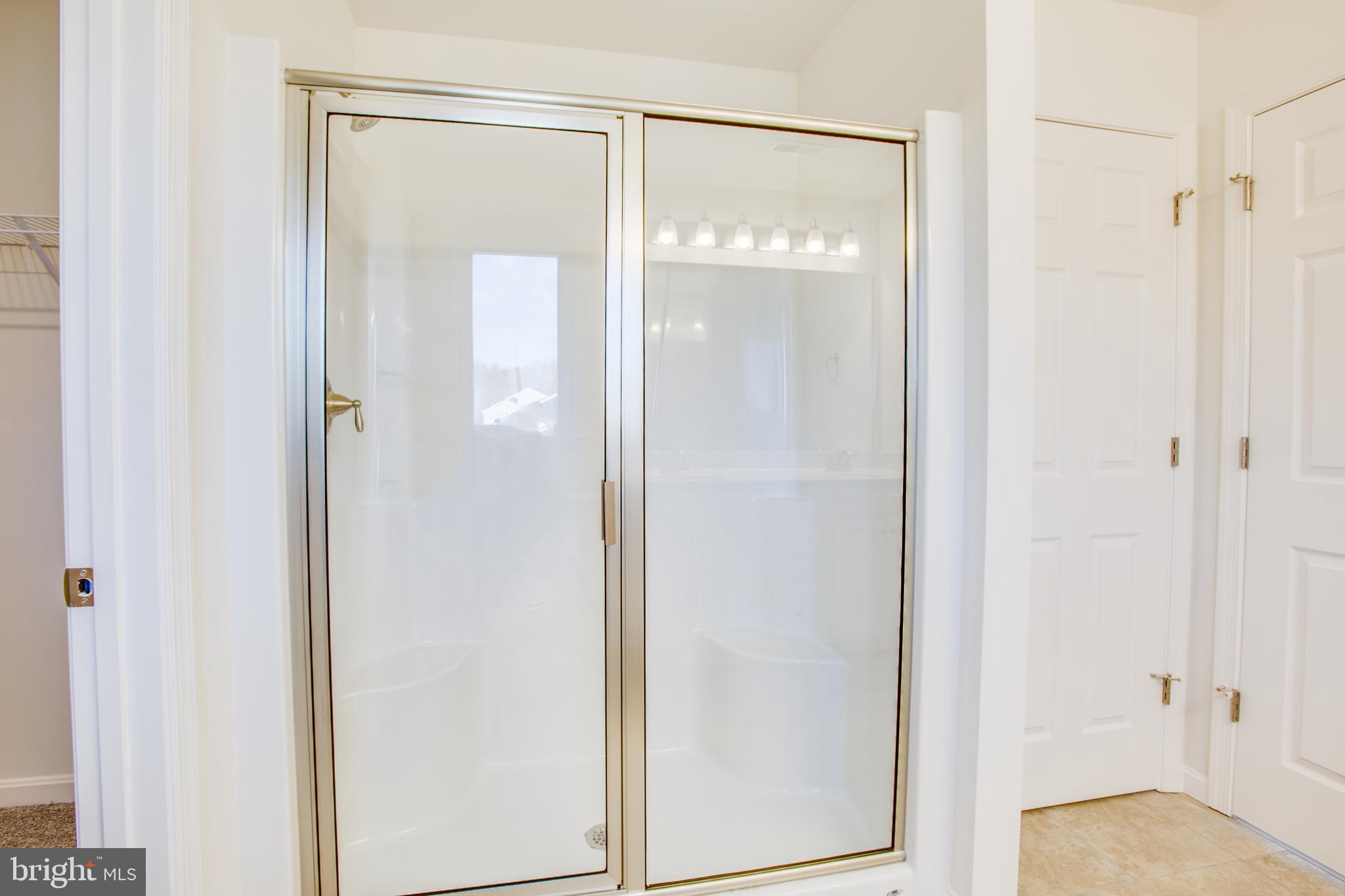 2107 Warrenton Road Fredericksburg, VA 22406 - Photo 31 of 58 a bathroom with a glass shower door