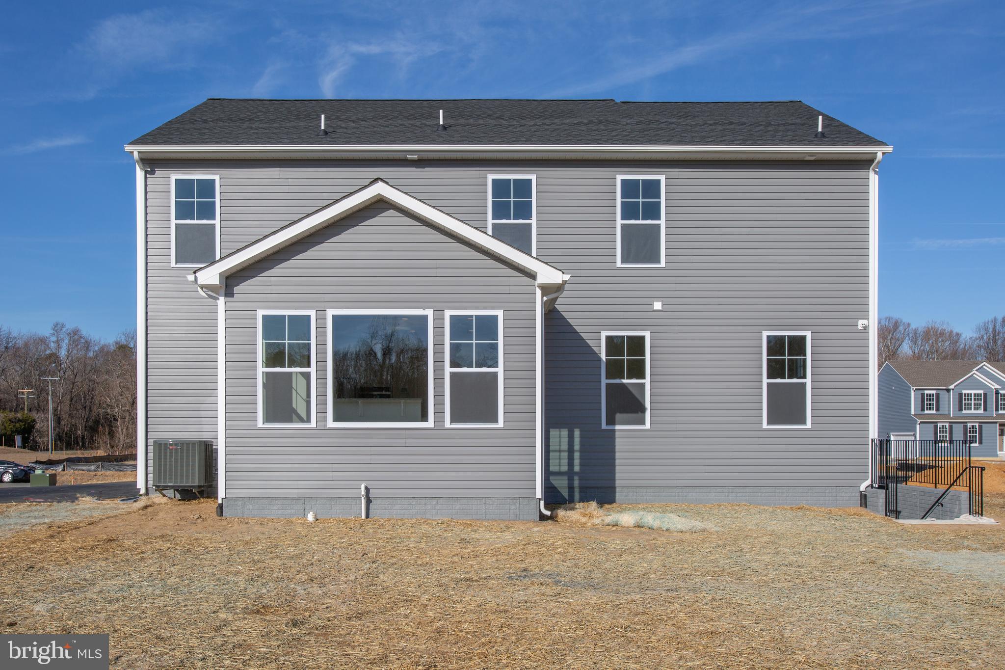 2107 Warrenton Road Fredericksburg, VA 22406 - Photo 54 of 58 a front view of a house with a yard and garage