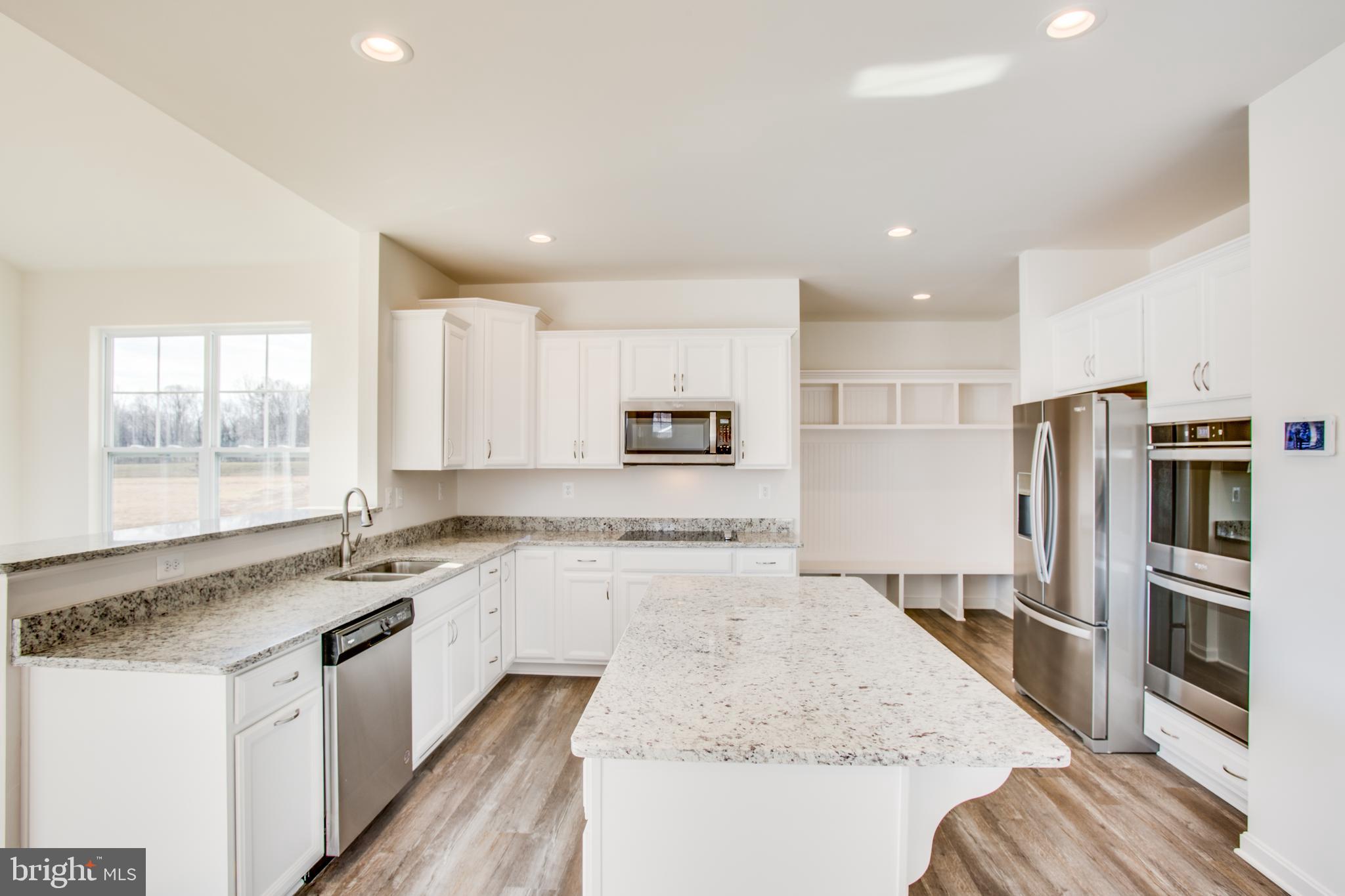 2107 Warrenton Road Fredericksburg, VA 22406 - Photo 6 of 58 a large kitchen with stainless steel appliances granite countertop a stove a sink and a refrigerator