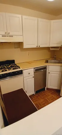 a kitchen with granite countertop a stove and a sink