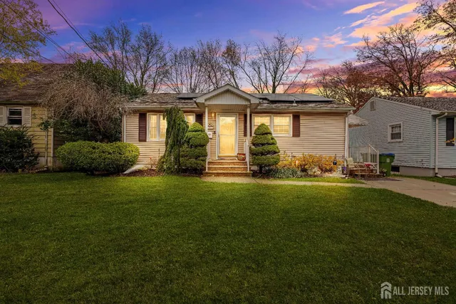 a front view of a house with a garden