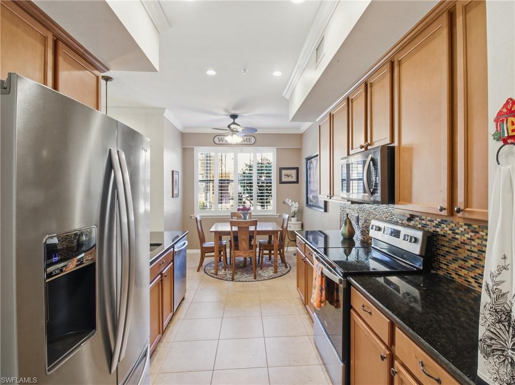 20161 Bravada Street, Unit 2 Estero, FL 33928 - Photo 10 of 33 a kitchen with granite countertop a refrigerator stove and sink
