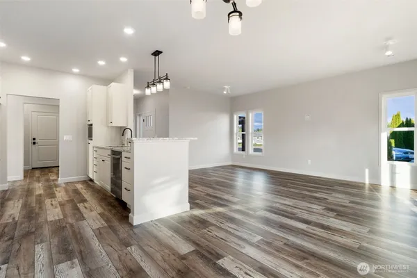 a view of a kitchen with furniture and wooden floor