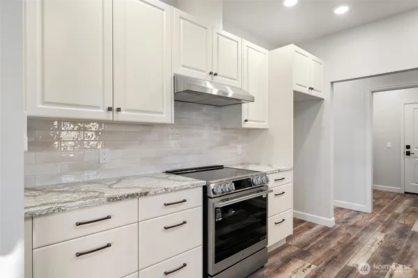 a kitchen with stainless steel appliances granite countertop a stove and a refrigerator