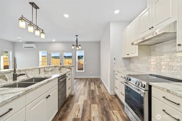 a kitchen with a sink stove and cabinets