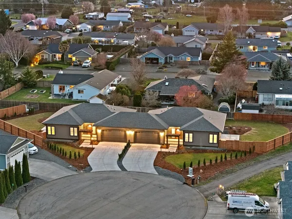 an aerial view of multiple houses with yard