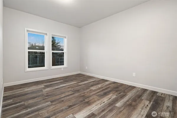 a view of a room with wooden floor and window