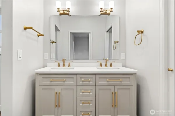 a bathroom with a granite countertop sink vanity and a mirror