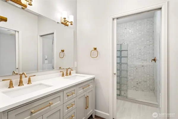 a bathroom with a shower sink and mirror