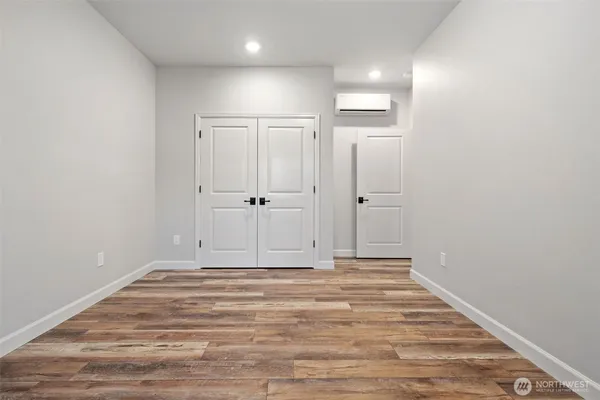 a view of room with wooden floor