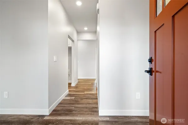 a view of a hallway with a wooden floor