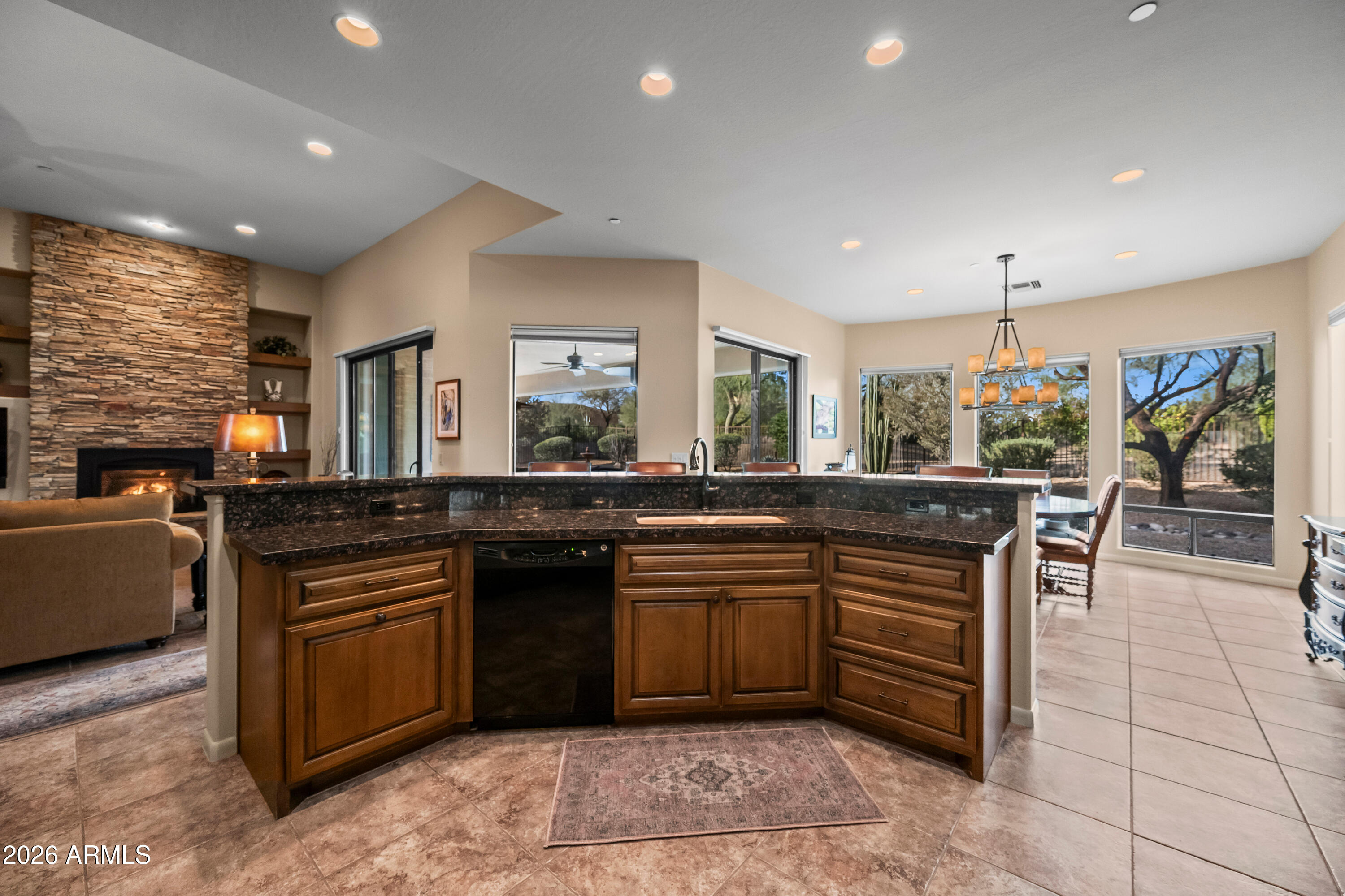 27940 North Walnut Creek Road Rio Verde, AZ 85263 - Photo 11 of 38 a kitchen with stainless steel appliances granite countertop dining table chairs sink and wooden floor