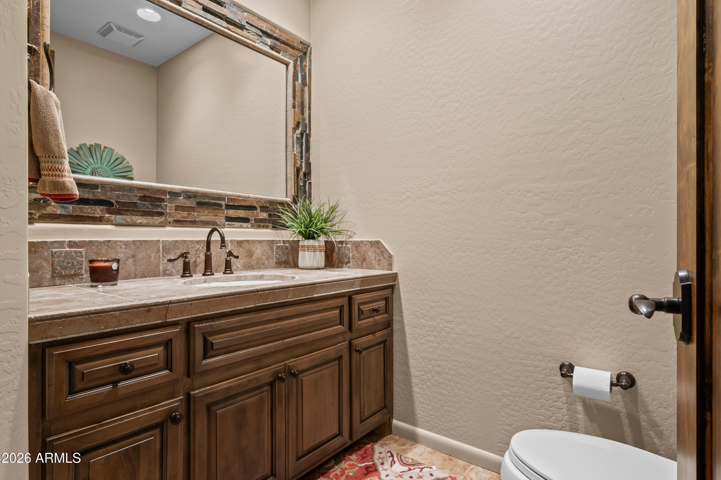 27940 North Walnut Creek Road Rio Verde, AZ 85263 - Photo 27 of 38 a bathroom with a toilet a sink and mirror