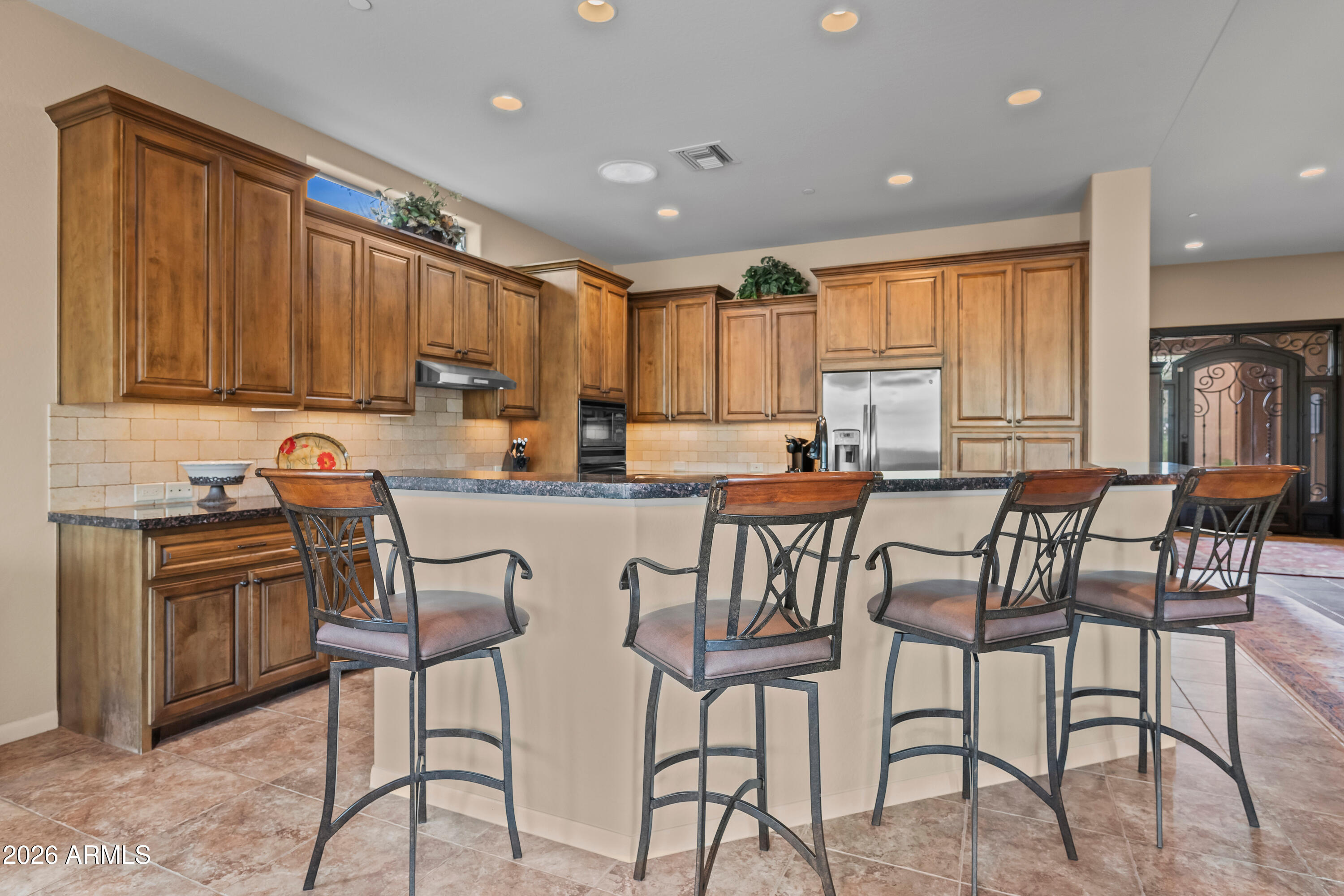 27940 North Walnut Creek Road Rio Verde, AZ 85263 - Photo 9 of 38 a kitchen with stainless steel appliances granite countertop table chairs sink and cabinets