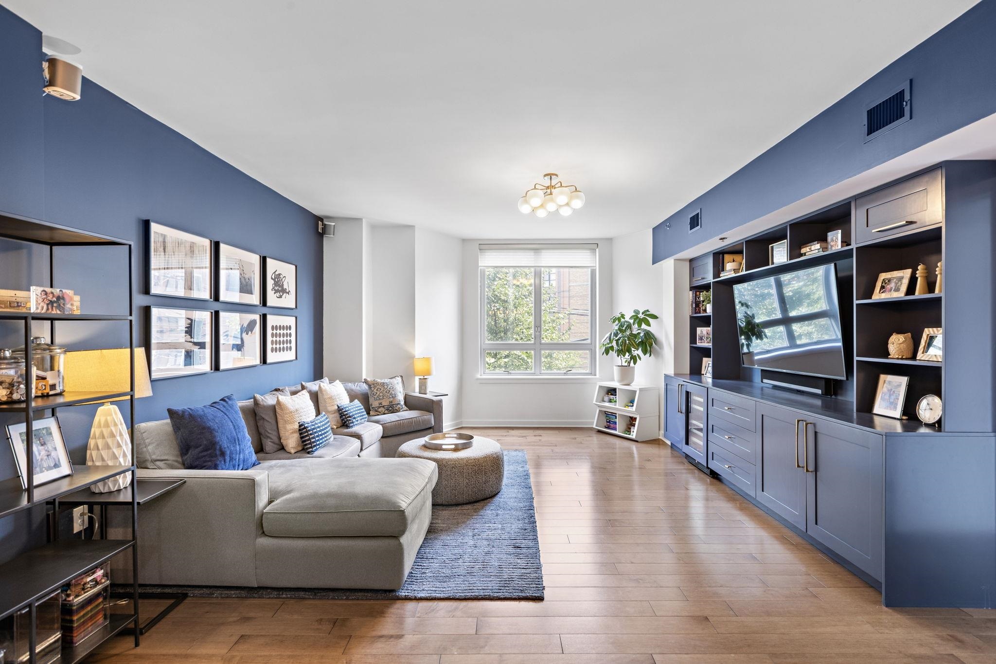 a living room with fireplace furniture and a flat screen tv