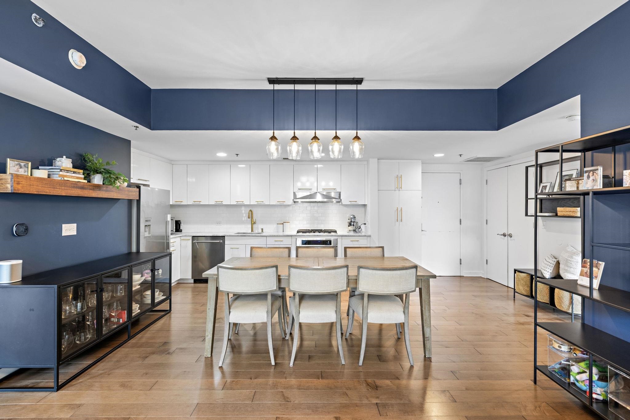 609 Observer Highway, Unit 303 Hoboken, NJ 07030 - Photo 5 of 20 a view of a dining room with furniture and wooden floor