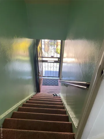 a balcony with stairs and wooden floor