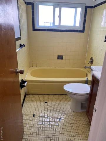 a bathroom with a toilet a sink and a bathtub