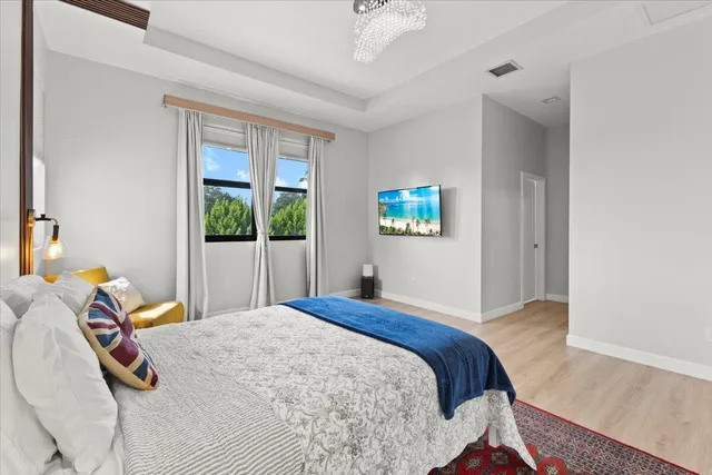 a bedroom with a bed and a window