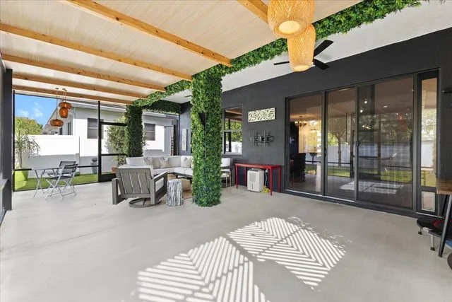 a bedroom with furniture and a large window