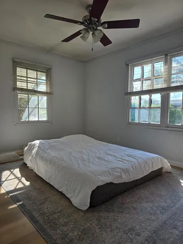 a bed sitting in a bedroom next to a window
