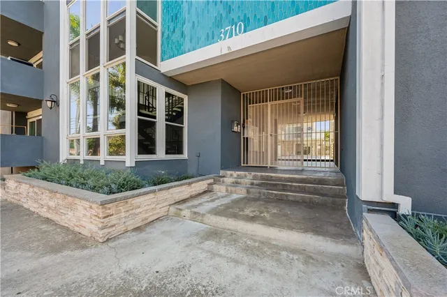 a view of entrance of house and car parked