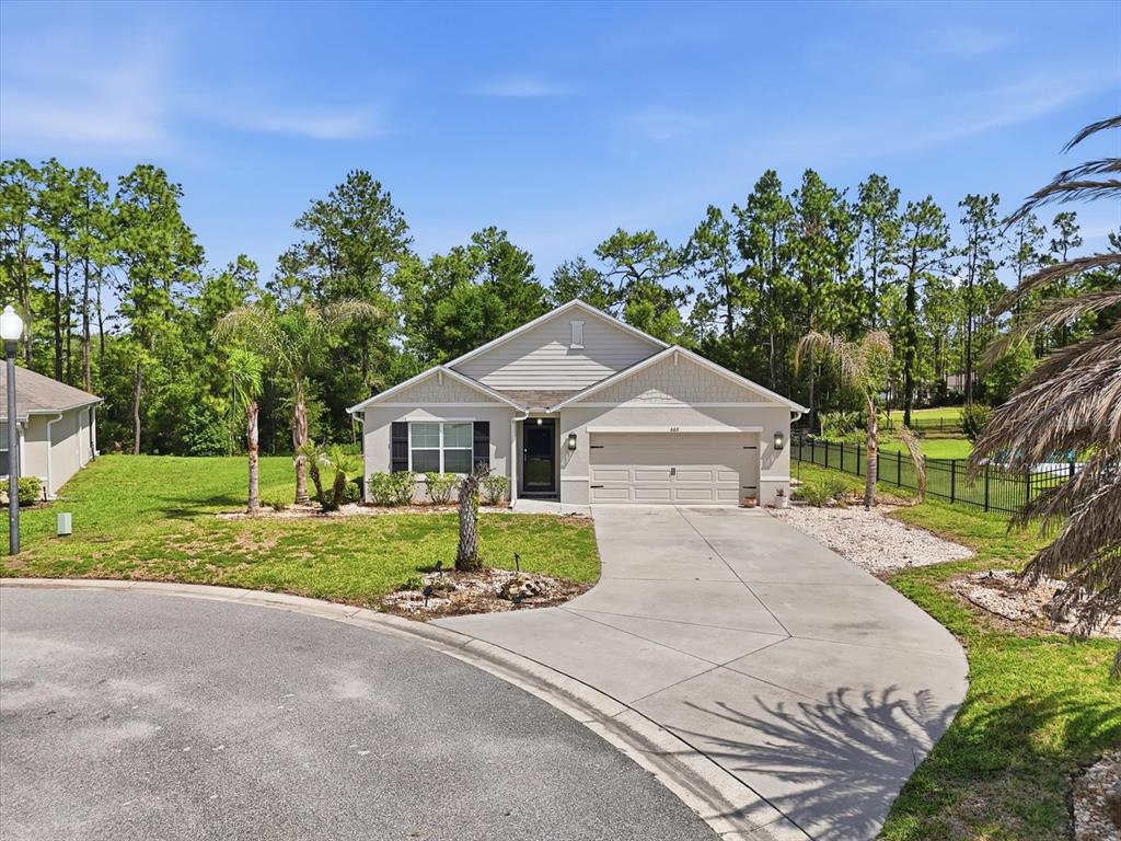660 Hickory Course Loop Ocala, FL 34472 - Photo 41 of 45 a front view of a house with a yard and garage