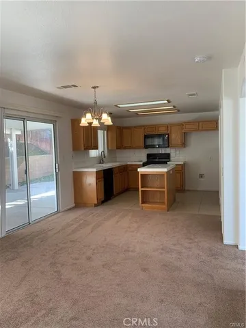 a view of a kitchen with a sink and stainless steel appliances
