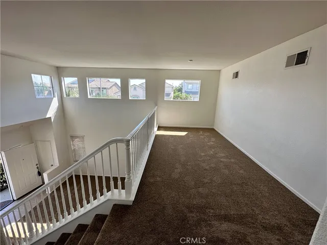a view of staircase with white walls