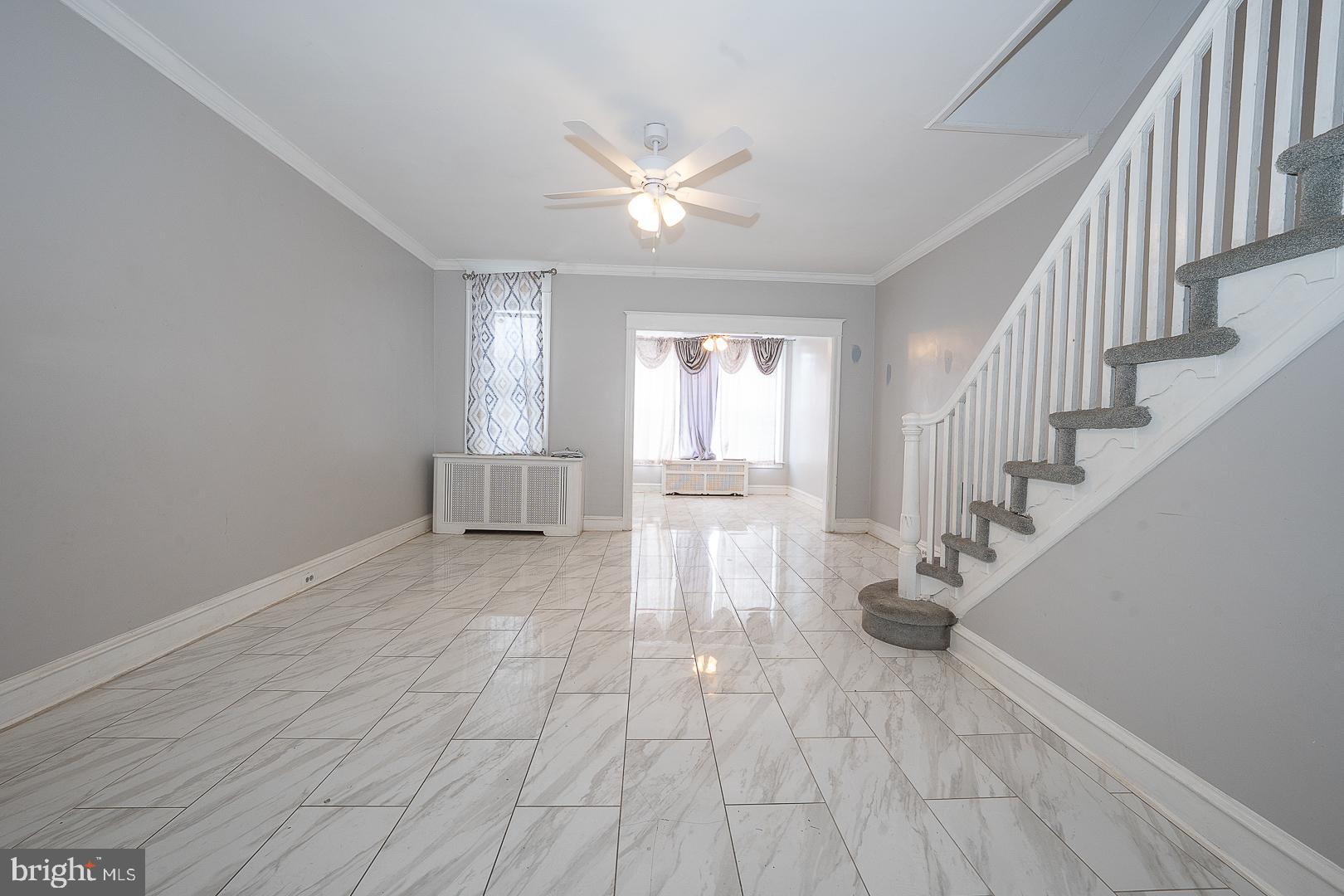 232 Copley Road Upper Darby, PA 19082 - Photo 12 of 47 a view of empty room with wooden floor and fan