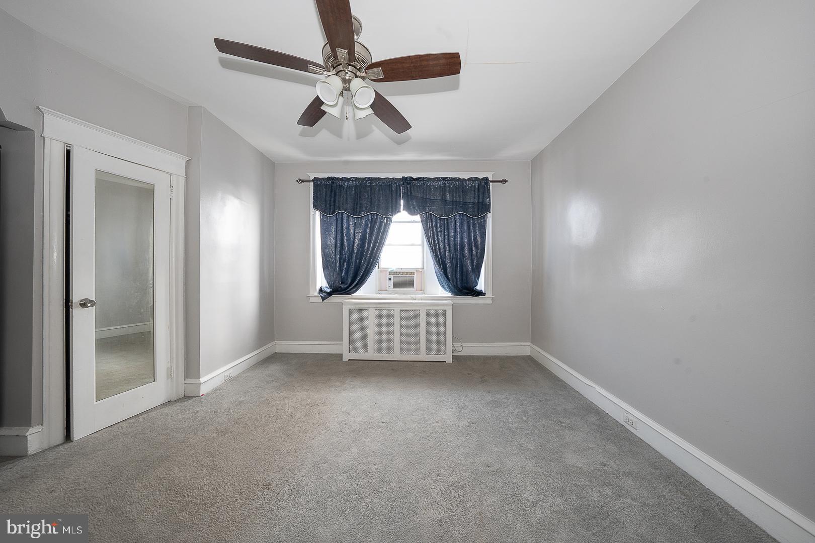 232 Copley Road Upper Darby, PA 19082 - Photo 22 of 47 an empty room with a ceiling fan and a window