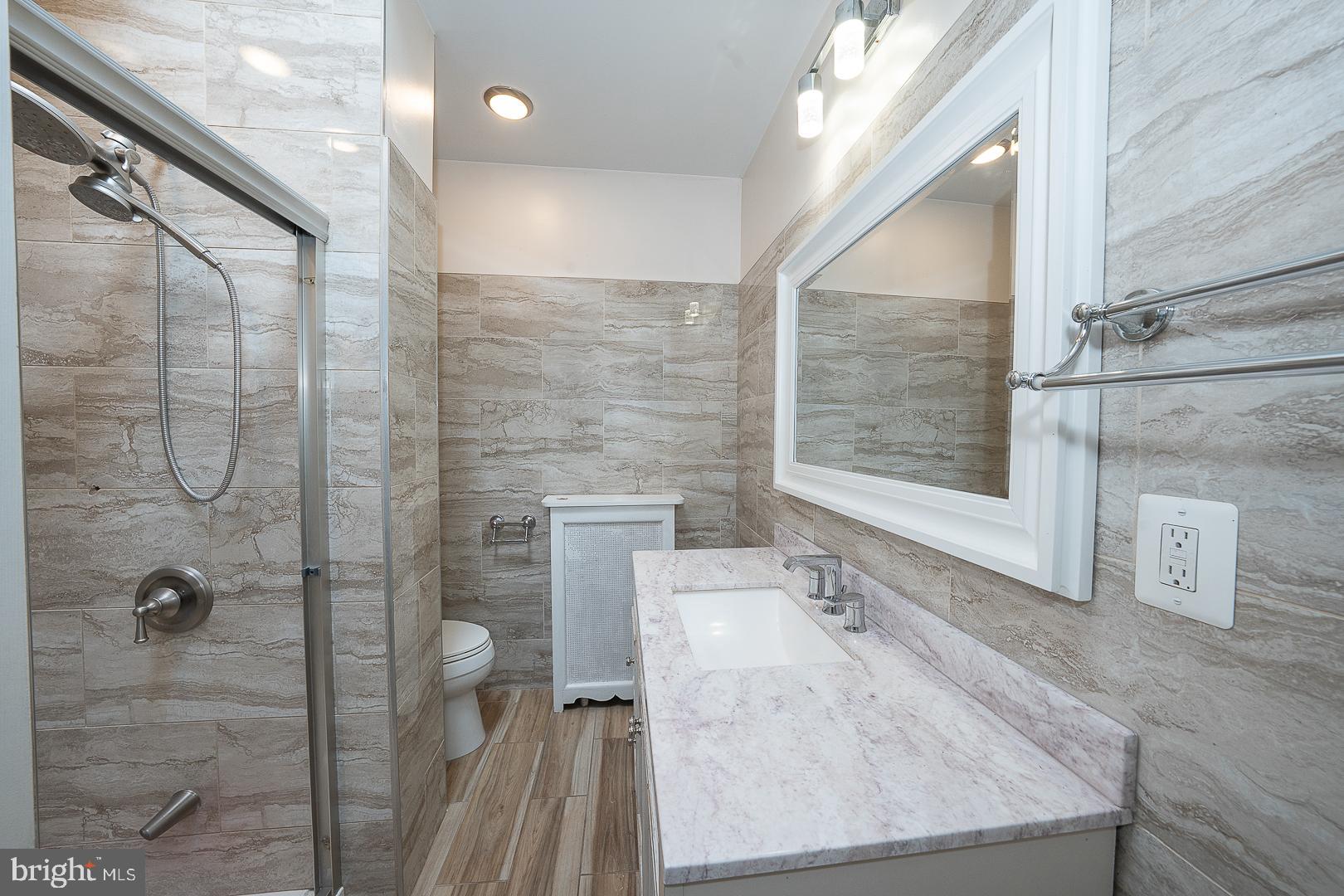 232 Copley Road Upper Darby, PA 19082 - Photo 28 of 47 a bathroom with a granite countertop shower