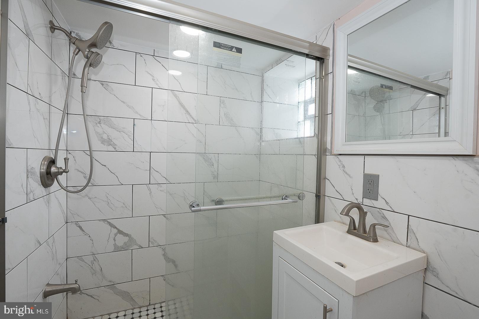232 Copley Road Upper Darby, PA 19082 - Photo 41 of 47 a bathroom with a sink mirror and vanity