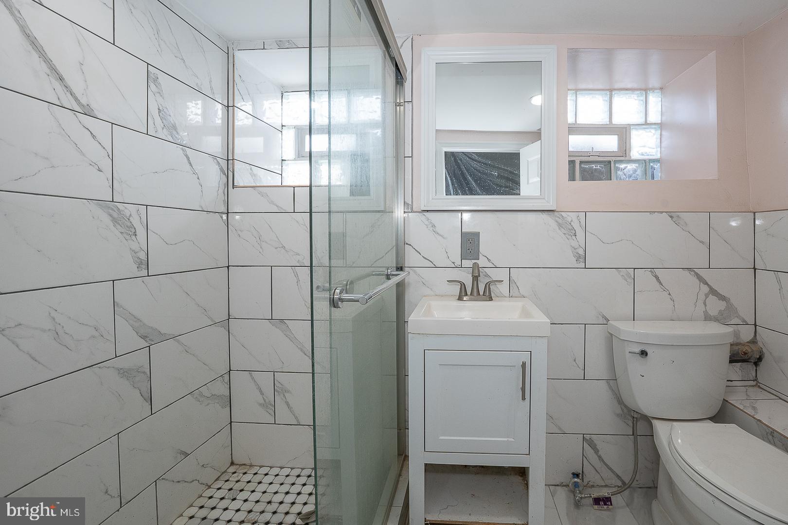 232 Copley Road Upper Darby, PA 19082 - Photo 42 of 47 a bathroom with a sink toilet and shower