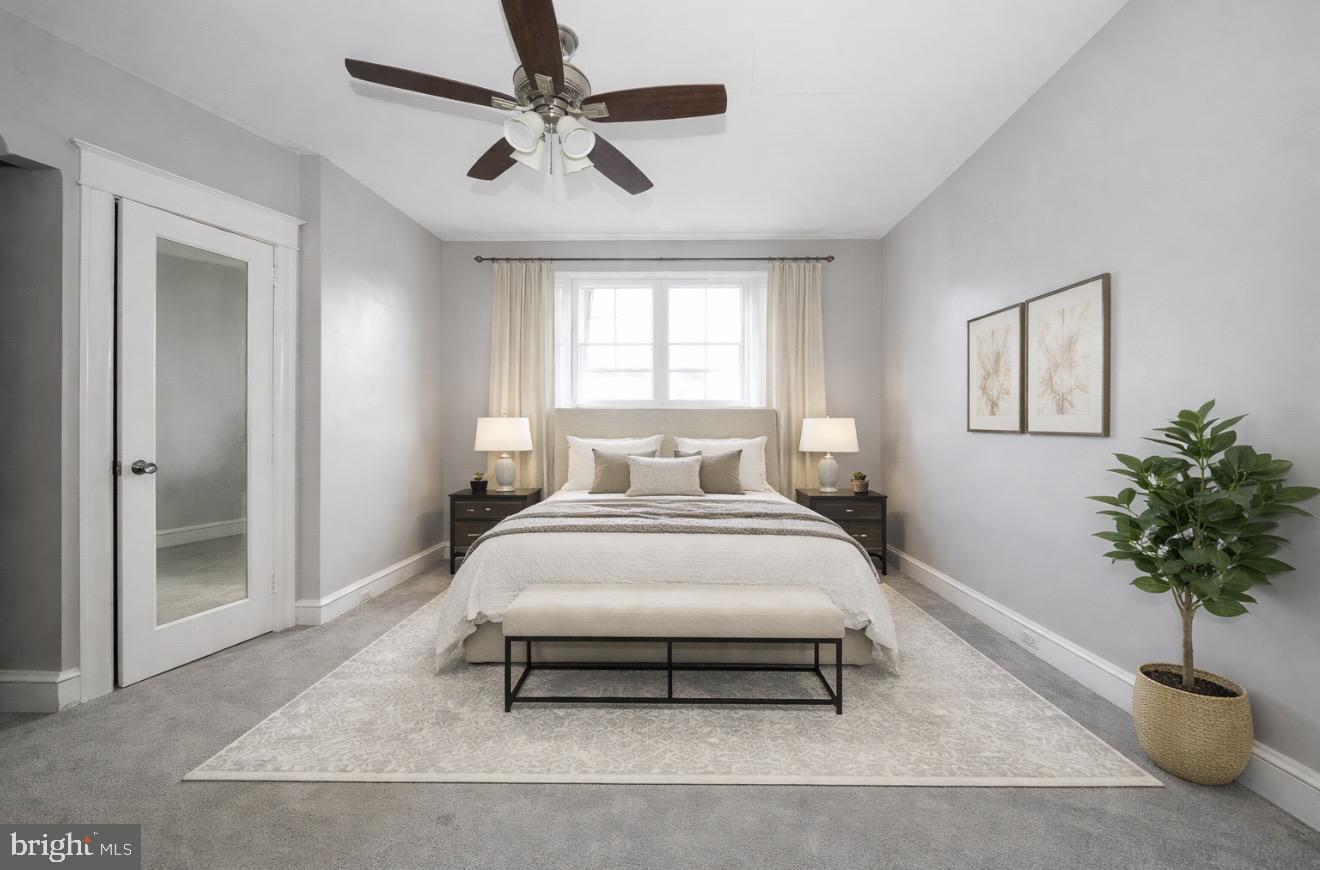 232 Copley Road Upper Darby, PA 19082 - Photo 5 of 47 a bedroom with a bed and a potted plant