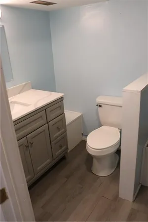 a white toilet sitting next to a bathroom sink