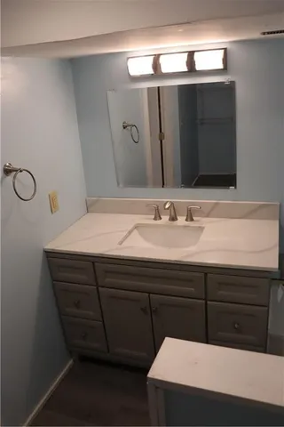 a bathroom with a sink vanity and a mirror