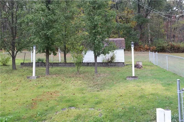 a backyard of apartments with large trees